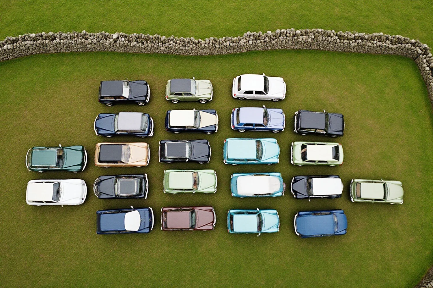 Classic cars in a row on grass, seen from directly above